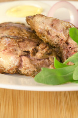Roasted chicken liver with vegetable on wooden background