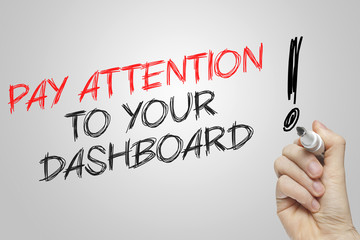 Hand writing pay attention to your dashboard