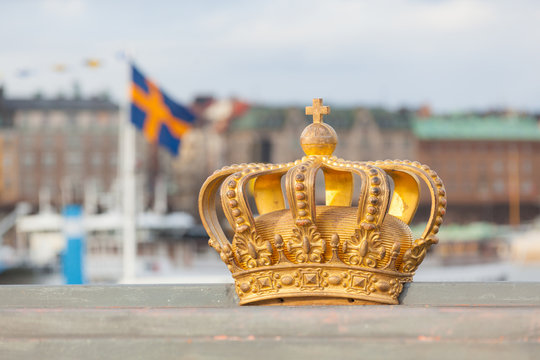 Golden crown with swedish flag on background in Stockholm