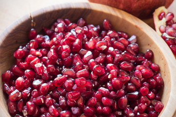 raw pomegranates on a wooden background