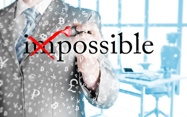 Businessman Hand turning the word Impossible into Possible with