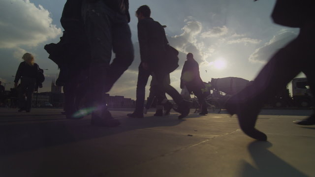 Crowds walking in slow motion during the setting sun