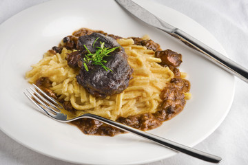 Slow cooked pork cheeks in gravy with spaetzle noodles