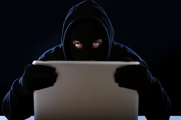 hacker with computer in digital intruder cyber crime concept