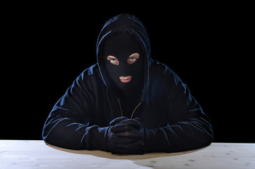 criminal terrorist man in hood mask secret illegal crime concept