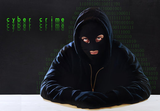 criminal in hood as digital hacker in cyber crime concept