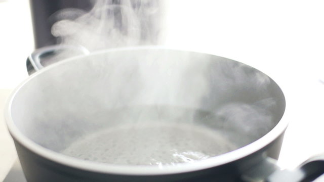 Closeup of boiling water in pot, slow motion shot at 240fps
