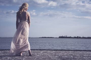 Wind blowing evening gown at lake