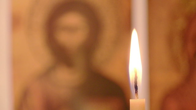 Candle in the background of the icons, close up