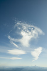 Naklejka na ściany i meble White cirrus clouds at the sky