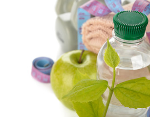 Bottle of water and a green leaf