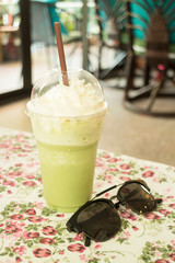 Glass of green tea latte frappe