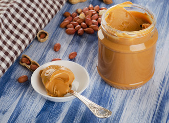 Peanut butter in  spoon  with peanuts.