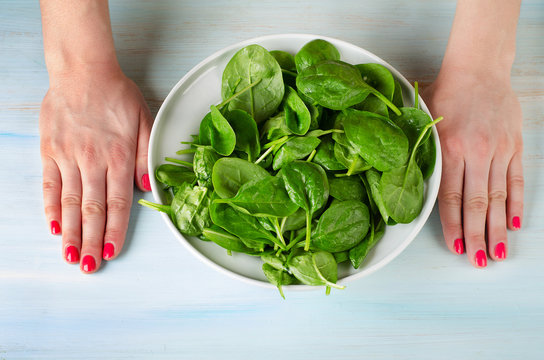 woman hands with  a green spinash