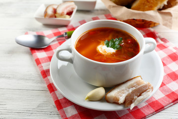 Ukrainian beetroot soup - borscht, on napkin, on wooden background
