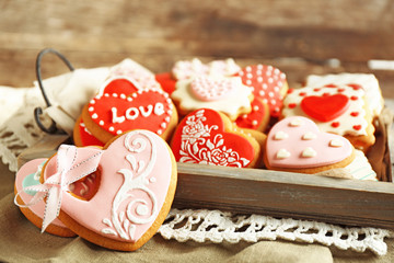 Heart shaped cookies for valentines day on tray, on wooden background
