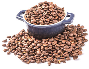 Roasted coffee beans in a blue ceramic pot over white background