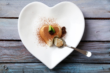 Tasty panna cotta dessert on plate, on wooden table