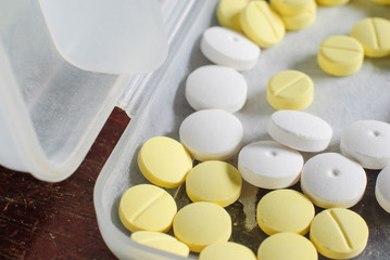 white and yellow round medicine tablet
