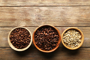 Coffee beans on wooden table, top view