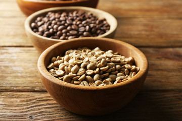 Coffee beans on wooden table, closeup