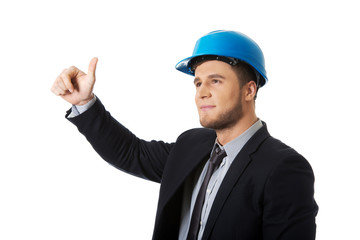 Happy businessman in helmet whit thumbs up.