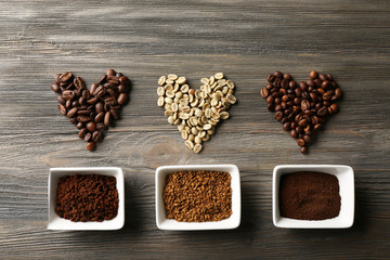 Coffee beans in shape of hearts on wooden background