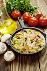 Omelet with mushrooms and tomatoes. Frittata