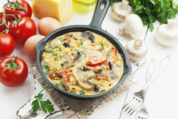 Omelet with mushrooms and tomatoes. Frittata