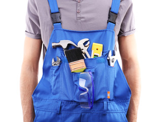 Man in coveralls with tools in his pocket isolated on white