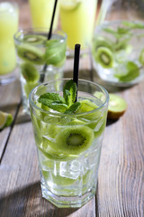 Glasses of cocktails on wooden table, closeup