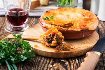 Juicy meat pot pie in a ceramic oven pot