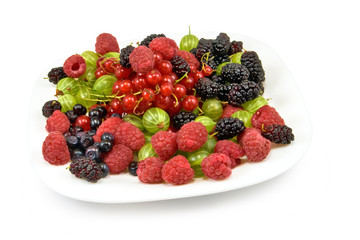 different berries in a plate on a white background