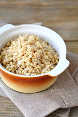 Boiled pearl barley in a ceramic pot
