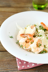 Rice with shrimp and dill on white plate