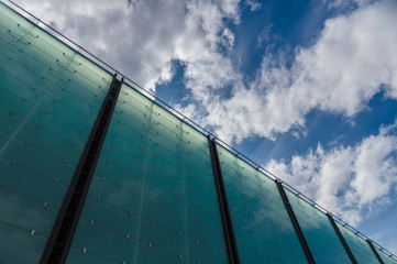 Modern glass architecture building cloudscape diagonal view