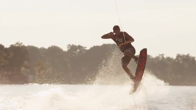 USA, Florida, Orlando, Maitland Lake. Young man on wakeboard