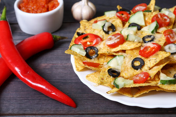 Mexican hot nachos with vegetables and chili