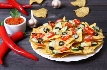 Mexican hot nachos with vegetables and chili