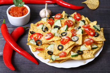 Mexican hot nachos with vegetables and chili