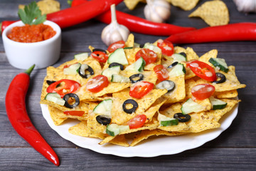 Mexican hot nachos with vegetables and chili