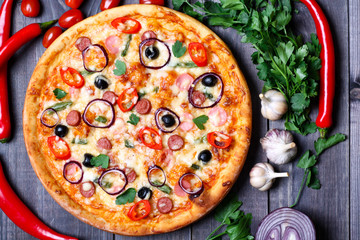 pizza with sausage, olives and chili pepper