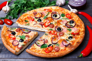 pizza with sausage, olives and chili pepper