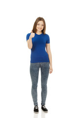 Happy female student showing thumbs up.