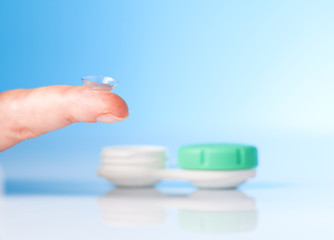 contact lens on finger and lenses case