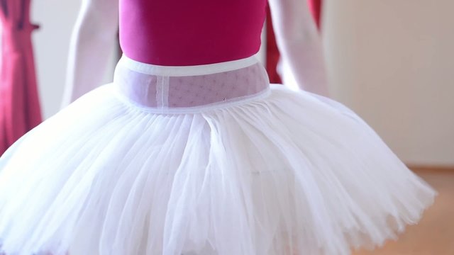 ballerina prepares for dancing - ballerina adjusts skirt