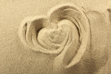 Fototapeta na wymiar Heart drawn on sand. Top view