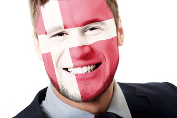 Happy man with Denmark flag on face.