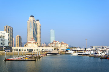 Fototapeta na wymiar Building and boat at seashore in Dalian