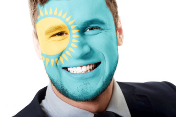 Happy man with Kazakhstan flag on face.